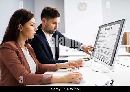 Reading Legal Law Contract On Desktop Computer Screen Stock Photo