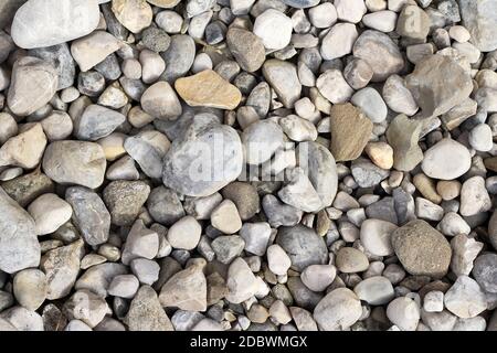 Background image with grey and beige stones and pebbles on the floor Stock Photo
