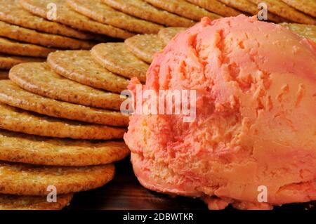 A port wine and cheddar cheese ball with whole wheat crackers Stock Photo