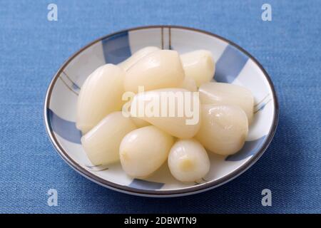 Japanese Rakkyo, Sweet and sour pickled scallions in a dish Stock Photo