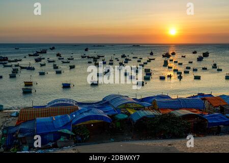 The beach and fisher boats in the bay of Mui Ne in Vietnam Stock Photo