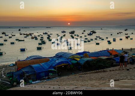 The beach and fisher boats in the bay of Mui Ne in Vietnam Stock Photo