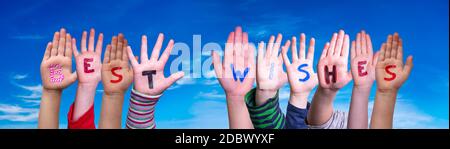 Children Hands Building Colorful English Word Best Wishes. Blue Sky As Background Stock Photo