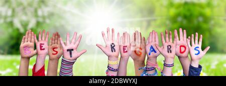 Children Hands Building Colorful English Word Best Regards. Sunny Green Grass Meadow As Background Stock Photo