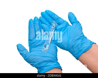 Bottle of injections in the arm, doctor's hands in medical gloves. Liquid medicine or vaccine for treating viral diseases in a laboratory or hospital. Stock Photo