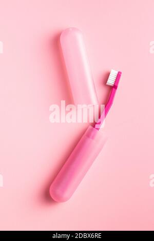 New pink toothbrush in case on pink background Stock Photo