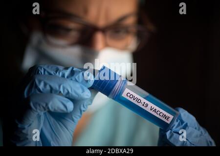 Conceptual image of a nurse holding a recipient with the coronavirus COVID-19 vaccine. Stock Photo