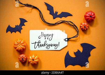 White Label With English Text Happy Thanksgiving. Halloween Decoration Like Bat. Autum Pumpkin Decoration On Orange Background Stock Photo