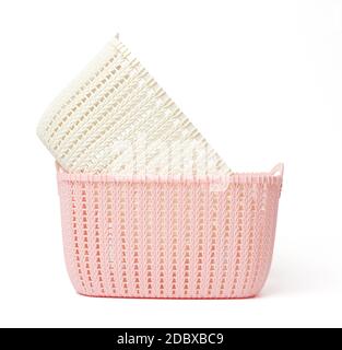 two empty plastic laundry baskets on white background Stock Photo
