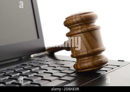 A judges gavel on a laptop to illustrate concepts of online legal services. Stock Photo