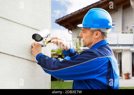 CCTV Security Camera Technician Professional And Electrician Stock Photo