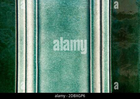 A Close Up Of Ceramic Tiling In A Variety Of Shades Of Green On The Facade Of A Building In London, UK Stock Photo