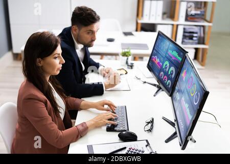 Financial Advisor And Business Analyst Working On Computer Stock Photo