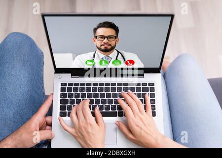 Pregnant Couple In Online Video Conference Call With Doctor Stock Photo
