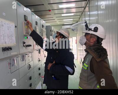 (201118) -- BUENOS AIRES, Nov. 18, 2020 (Xinhua) -- Technicians check the equipment at Cauchari Solar Park in the northwestern province of Jujuy, Argentina, Sept. 26, 2020. Cauchari Solar Park, built by China Power Construction and the Shanghai Electric Power Construction Company, is located in the town of Cauchari in the northwestern province of Jujuy, at an altitude of about 4,200 meters above sea level. The project, authorized by Argentina's Wholesale Electric Market Management Company, supplies the grid with a total of 300 megawatts of electricity and has useful life of approximately 2 Stock Photo