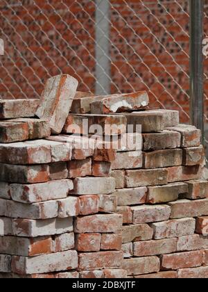 COLOR PHOTO OF PILE OF RED CLAY BRICKS IN CONSTRUCTION SITE Stock Photo