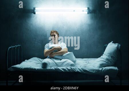 Premium Photo  Blindfolded crazy man sitting in bed, dark room..  psychedelic male person having problems every night, depression and stress,  sadness, psychiatry hospital