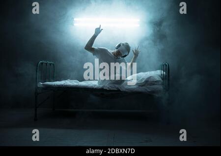 Mysterious image of a blindfolded man in a dark room stock photo