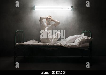 Premium Photo  Blindfolded crazy man sitting in bed, dark room..  psychedelic male person having problems every night, depression and stress,  sadness, psychiatry hospital