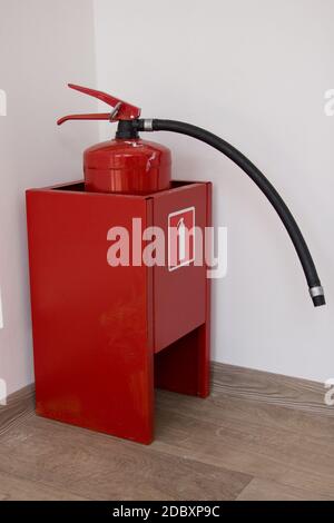 Dry chemical powder fire extinguisher in corridor. Stock Photo