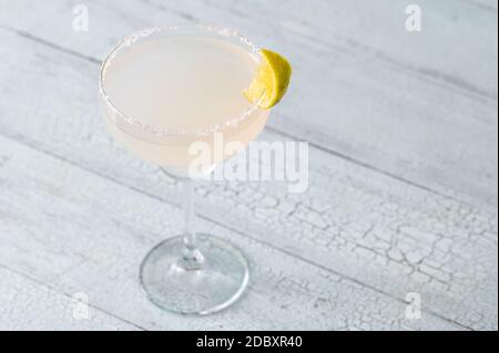 Glass of Margarita cocktail garnished with salt rim Stock Photo