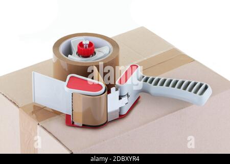 A brown cardboard box and parcel tape dispenser Stock Photo