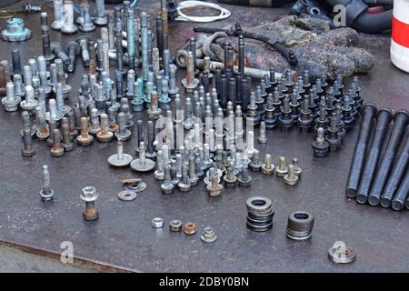 Screws bolts and nuts in upright position at work bench Stock Photo