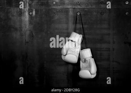 hanging boxing gloves black background