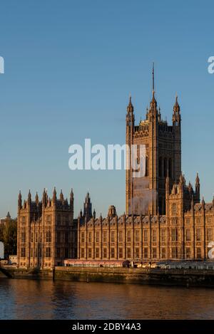 Smoke or steam rising from the Palace of Westminster, Houses of Parliament, on a bright, sunny but cold November day in London, UK. Victoria Tower Stock Photo