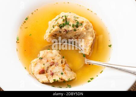 single speckknoedel in soup on wood Stock Photo