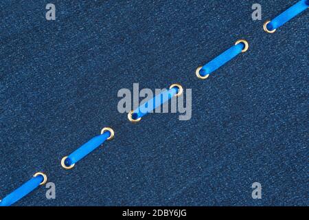 Fashionable background, blue satin ribbon inserted in denim, with space for your creativity Stock Photo