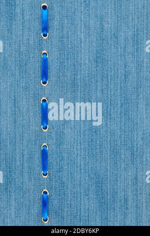 Fashionable background blue satin ribbon inserted in denim, with space for your creativity Stock Photo