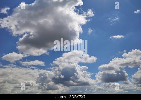 Cumulus clouds fly in blue sky Stock Photo