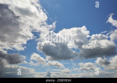 The sun behind the clouds lit up the blue sky Stock Photo