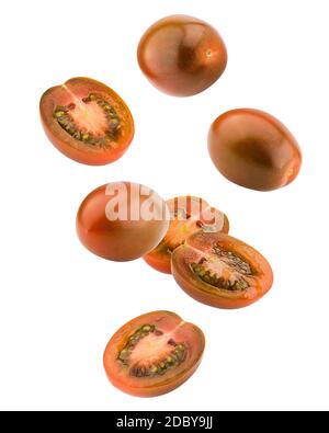 Falling kumato black tomato, cherry, isolated on white background, clipping path, full depth of field Stock Photo