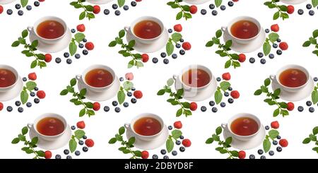 A Cup of tea, strawberries, blueberries and mint leaves on a white isolated background. Seamless pattern. Original packaging design Stock Photo