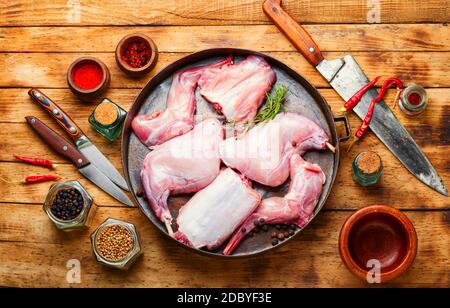 Pieces of raw rabbit meat on old wooden table.Fresh piece of rabbit Stock Photo