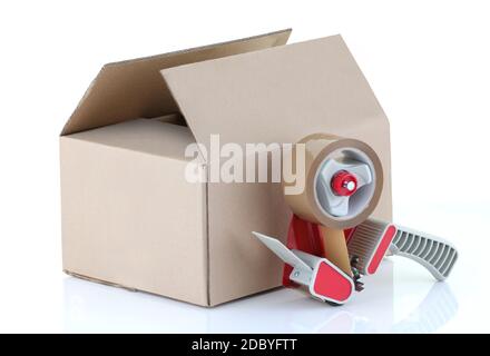 A cardboard box and packing tape gun on white Stock Photo