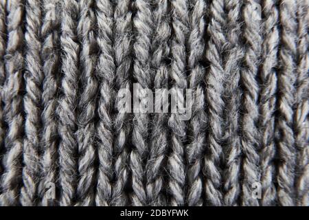 A grey ribbed knitted wool background texture macro with selective focus Stock Photo