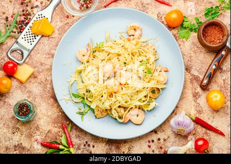 Italian pasta fettuccine with shrimp on a plate Stock Photo