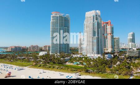 Aerial stock Miami Beach Spring break vacation. Beautiful sunny day at South Beach, Florida. Aerial over hotels, condos and beach goers on South Beach Stock Photo