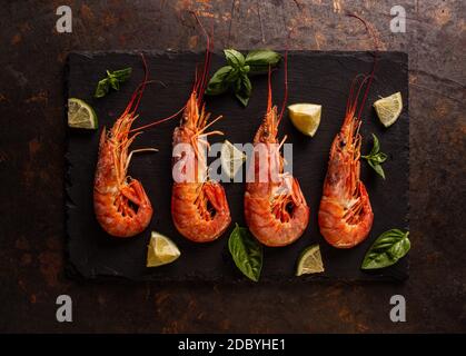 Top view of red big king prawns on black slate board Stock Photo