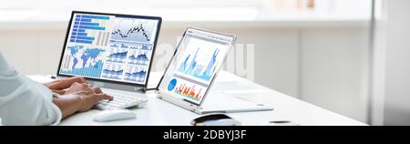 Analyst Employee Working With Spreadsheet Report On Laptop Screen Stock Photo