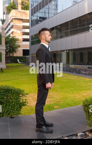 Full length profile view shot of businessman standing outdoors Stock Photo