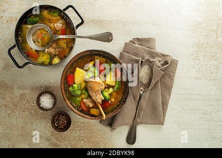 Serving healthy stew with rabbit meat and vegetables on grey background Stock Photo