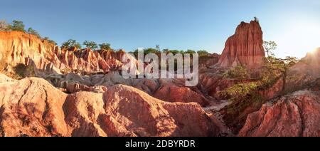 High resolution panorama of Marafa Depression (Hell's Kitchen canyon) with red and yellow cliffs and rocks in afternoon sunset back light. Malindi, Ke Stock Photo