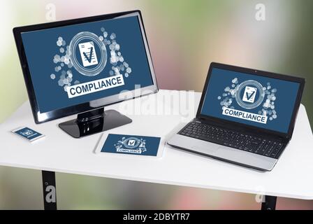 Compliance concept shown on different information technology devices Stock Photo