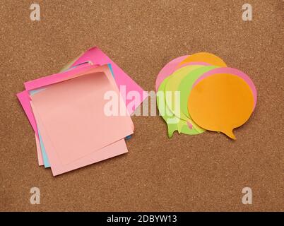 colorful paper stickers glued on brown balsa board, idea and multitasking, close up Stock Photo