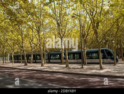 Bordeaux, France - September 9, 2018: The modern tram in the French city of Bordeaux, passing along the Allees de Munich, a leafy avenue in the center Stock Photo