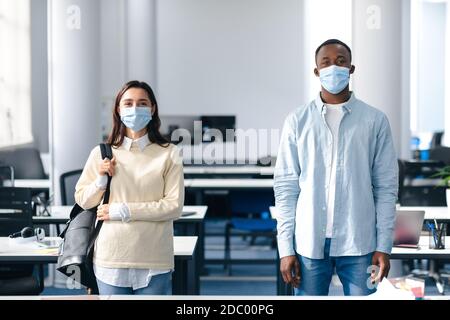Portrait of international students wearing protective medical masks Stock Photo